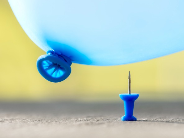 Balloon about to burst on thumbtack